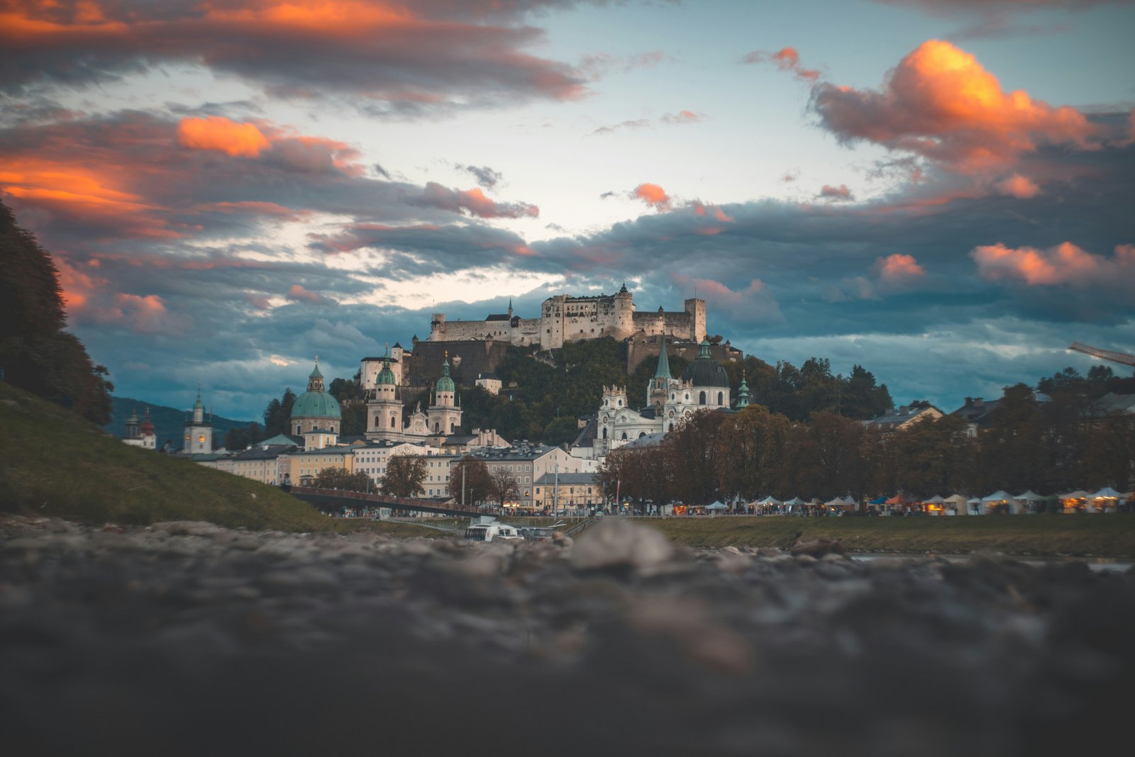 Iconic skyline of Salzburg, Austria, taken from the gravel banks of the Salzach River at dusk