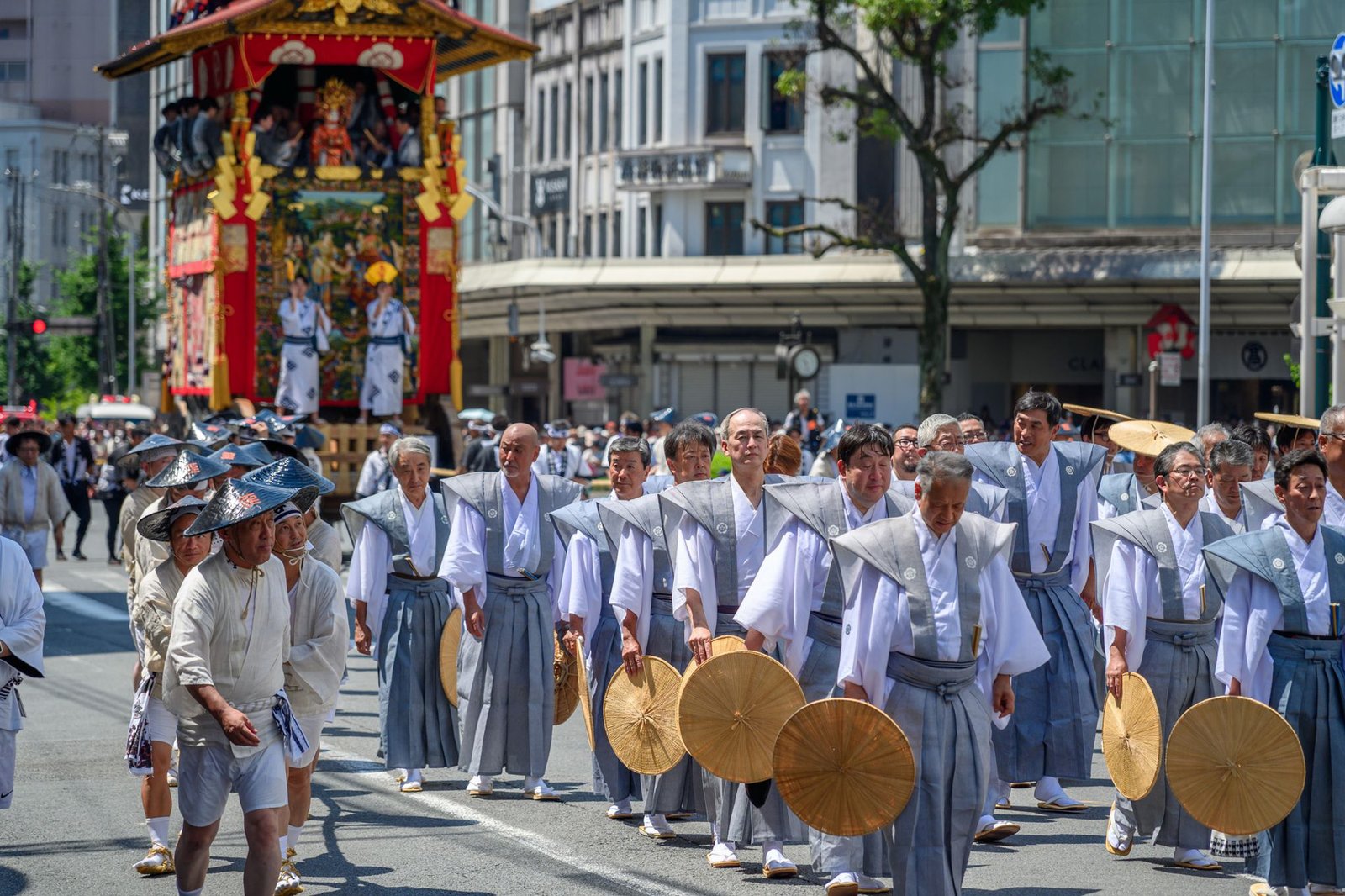 Participants in traditional attire marching in a vibrant cultural parade in Kyoto, Japan