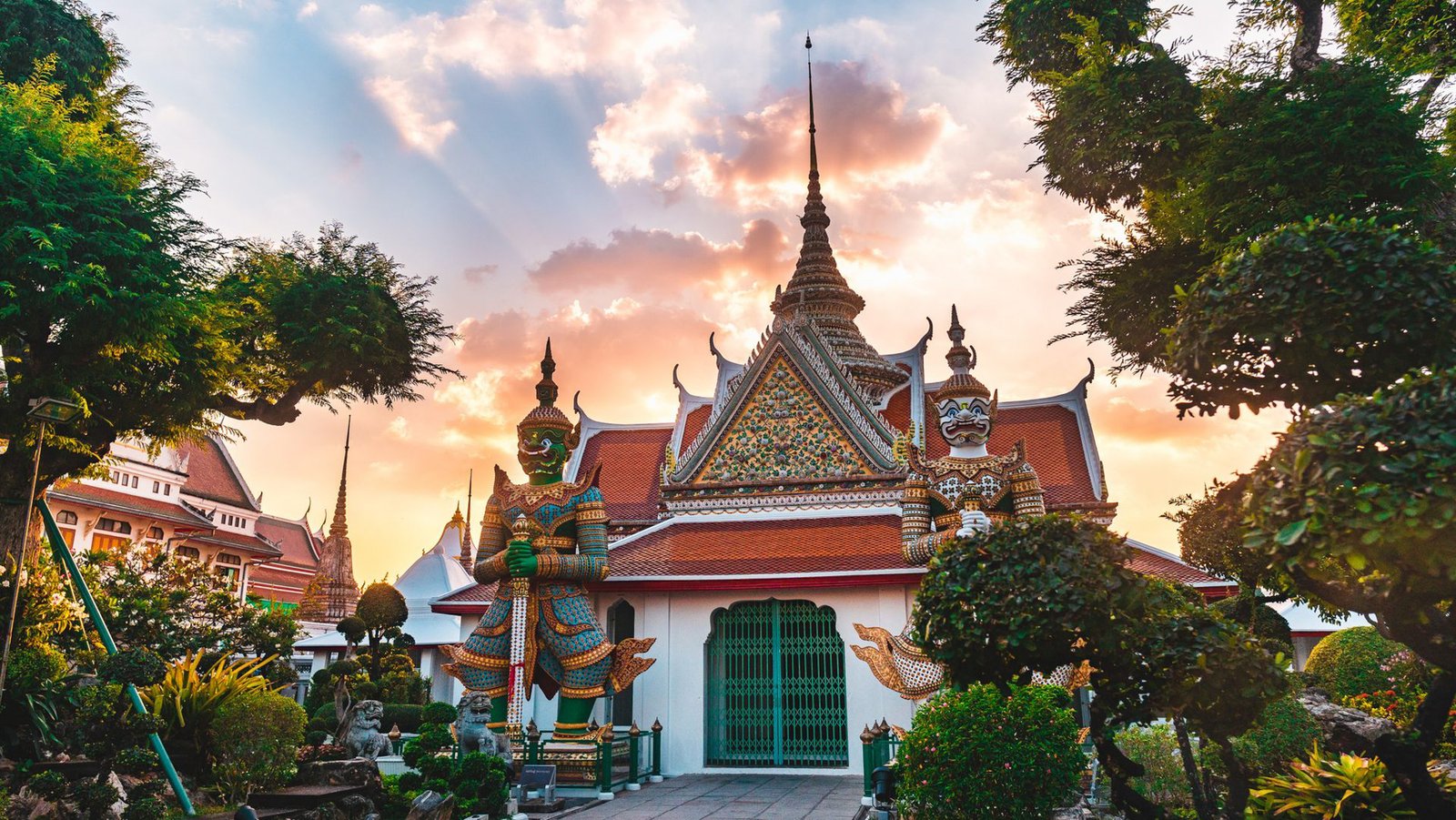 Stunning capture of Wat Arun in Bangkok with vibrant sunset and lush greenery