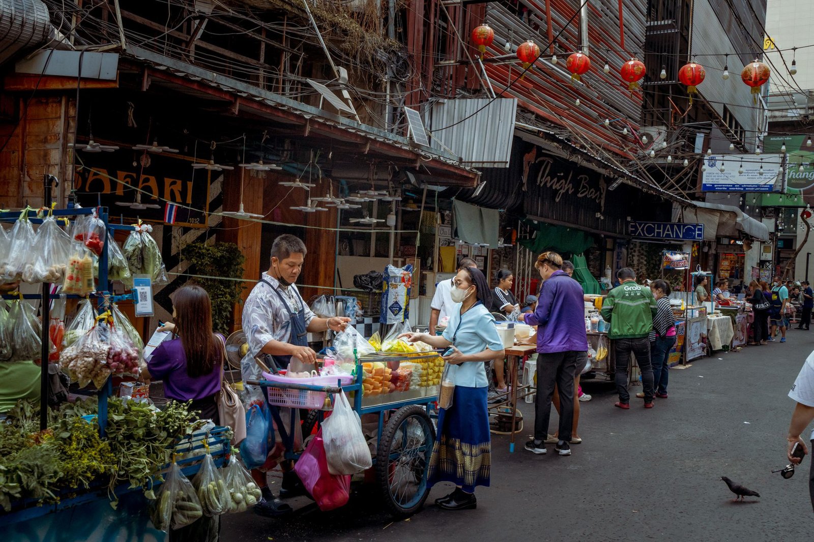 Vibrant street market scene in Asia with diverse vendors selling fresh produce - Bangkok, Thailand